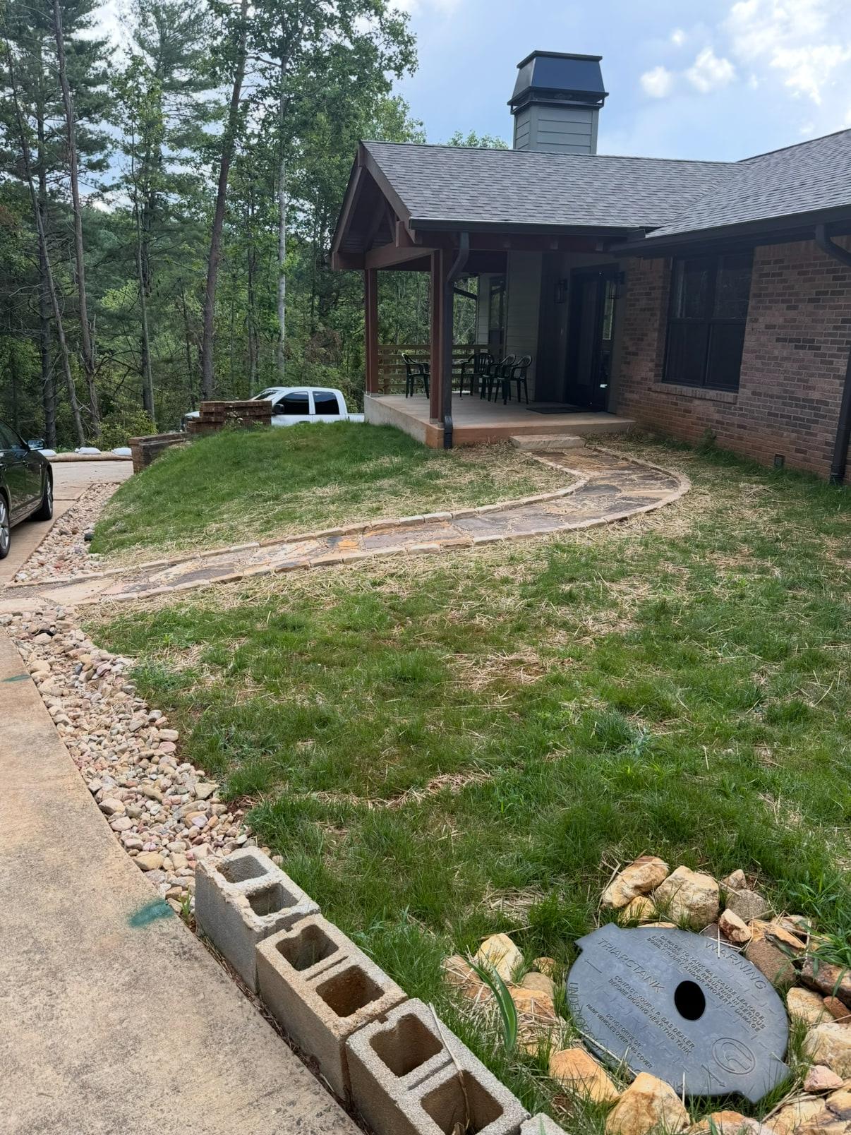Finished covered porch with cedar posts, flagstone walkway and established lawn